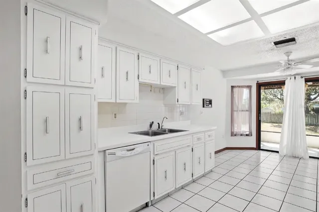 a kitchen with white cabinets and white appliances