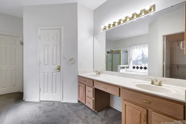 a bathroom with a double vanity sink and a mirror