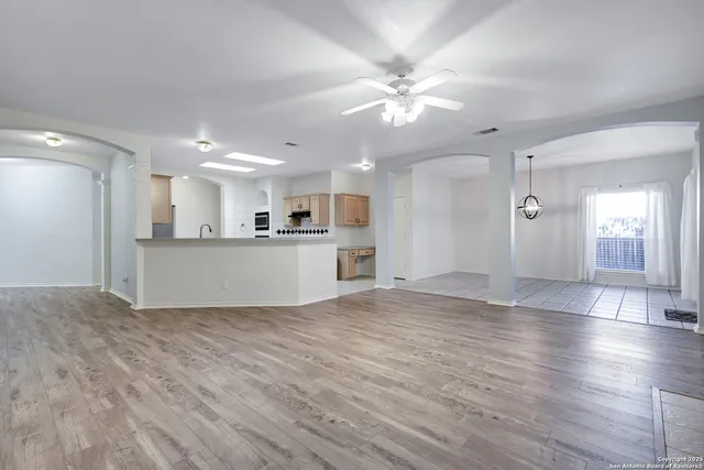 a view of a kitchen with wooden floor and window