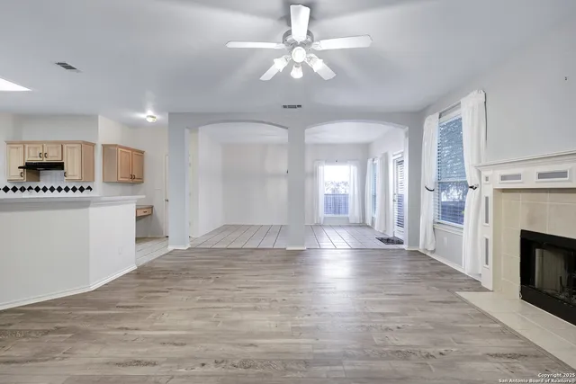 a view of a kitchen with a sink a fireplace a refrigerator and a stove top oven