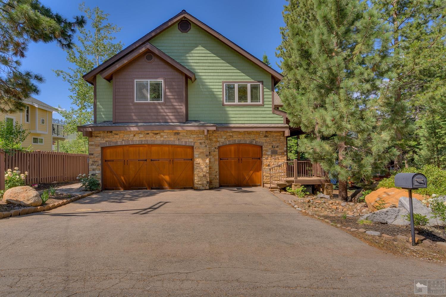 645 Zuni Street South Lake Tahoe, CA 96150 - Photo 1 of 30 a view of a house with a yard and garage