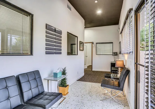 a kitchen with stainless steel appliances a refrigerator and a table