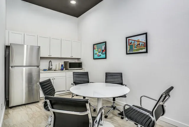 a view of a hallway with toilet and tub