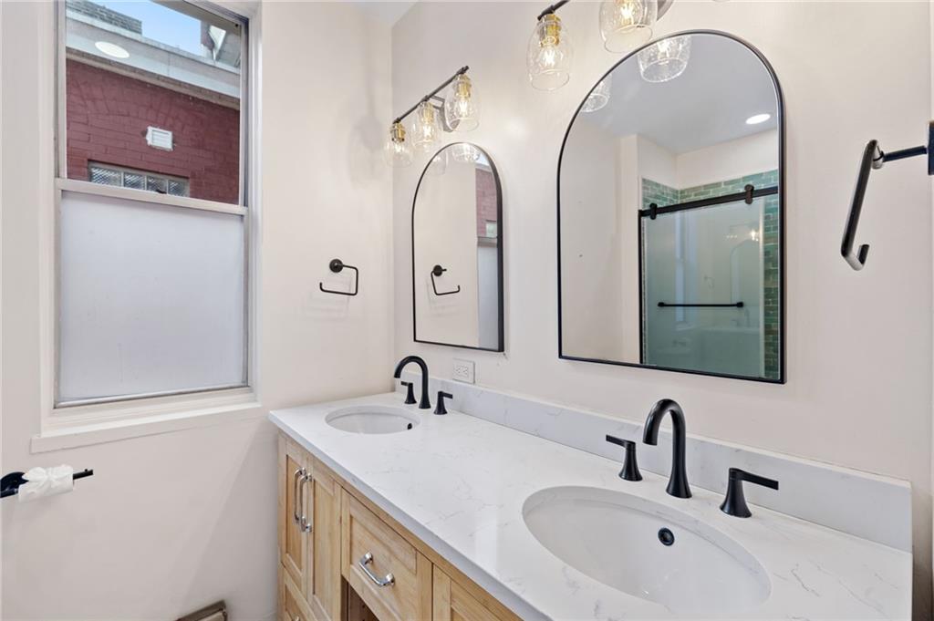 295 Fisk Street Pittsburgh, PA 15201 - Photo 13 of 29 a bathroom with a double vanity sink and a mirror