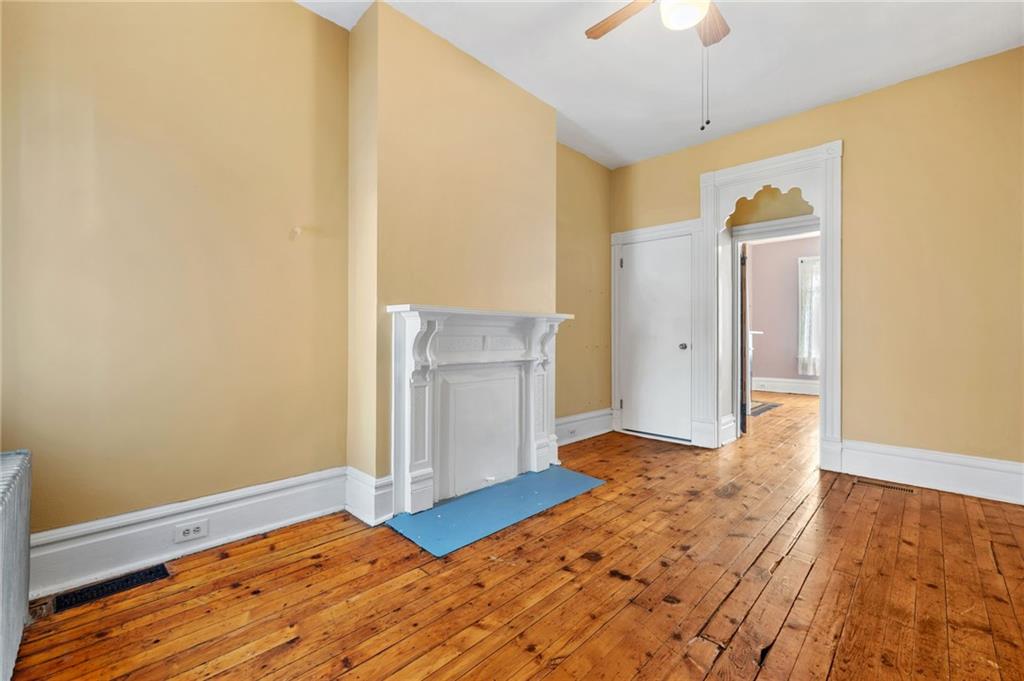 295 Fisk Street Pittsburgh, PA 15201 - Photo 18 of 29 a view of a livingroom with wooden floor and a ceiling fan