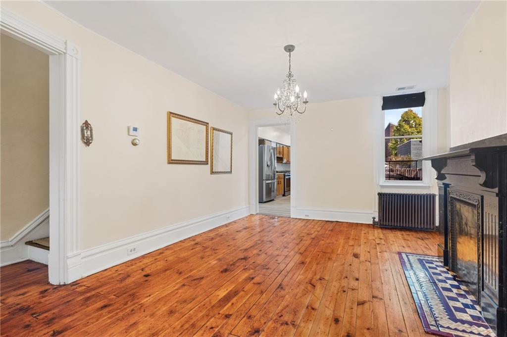 295 Fisk Street Pittsburgh, PA 15201 - Photo 10 of 29 a view of a room with wooden floor and chandelier
