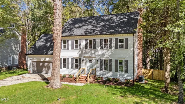a view of a house with a yard and sitting area