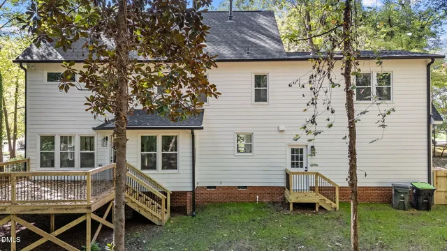 a view of house with a backyard