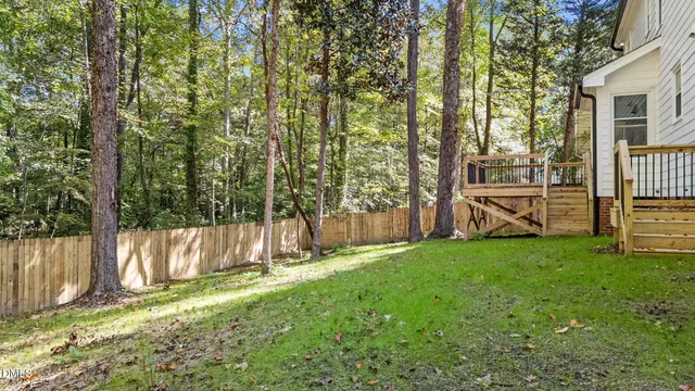 a view of a backyard with a garden and entertaining space