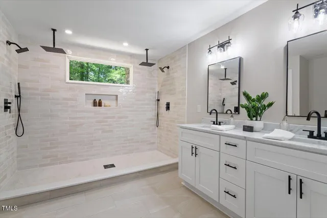a bathroom with a shower sink and mirror