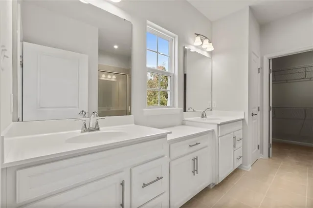 a bathroom with a double vanity sink mirror and
