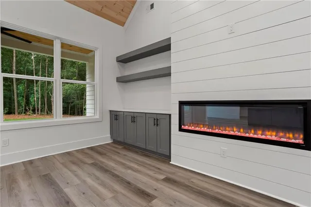 a living room with a fireplace and a floor to ceiling window