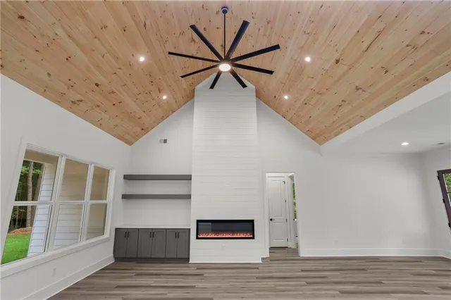 a view of a livingroom with a ceiling fan and wooden floor