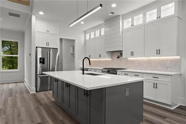 a kitchen with a sink stove and refrigerator