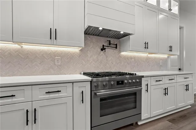 a stove top oven sitting inside of a kitchen