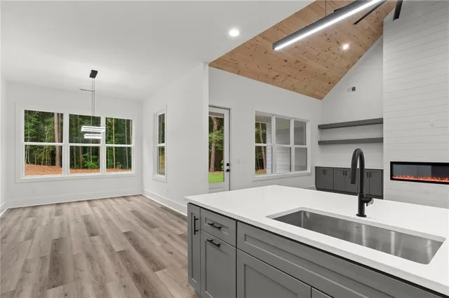 a kitchen with a sink and chandelier