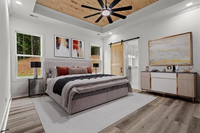 a spacious bedroom with a bed and a large window