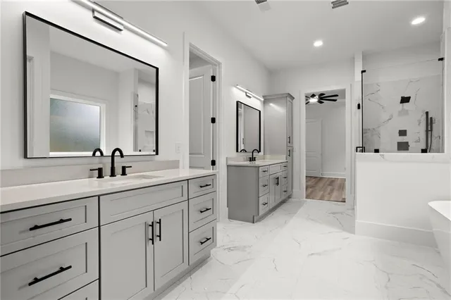 a bathroom with a double sink mirror and a bathtub