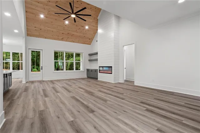 an empty room with window and wooden floor