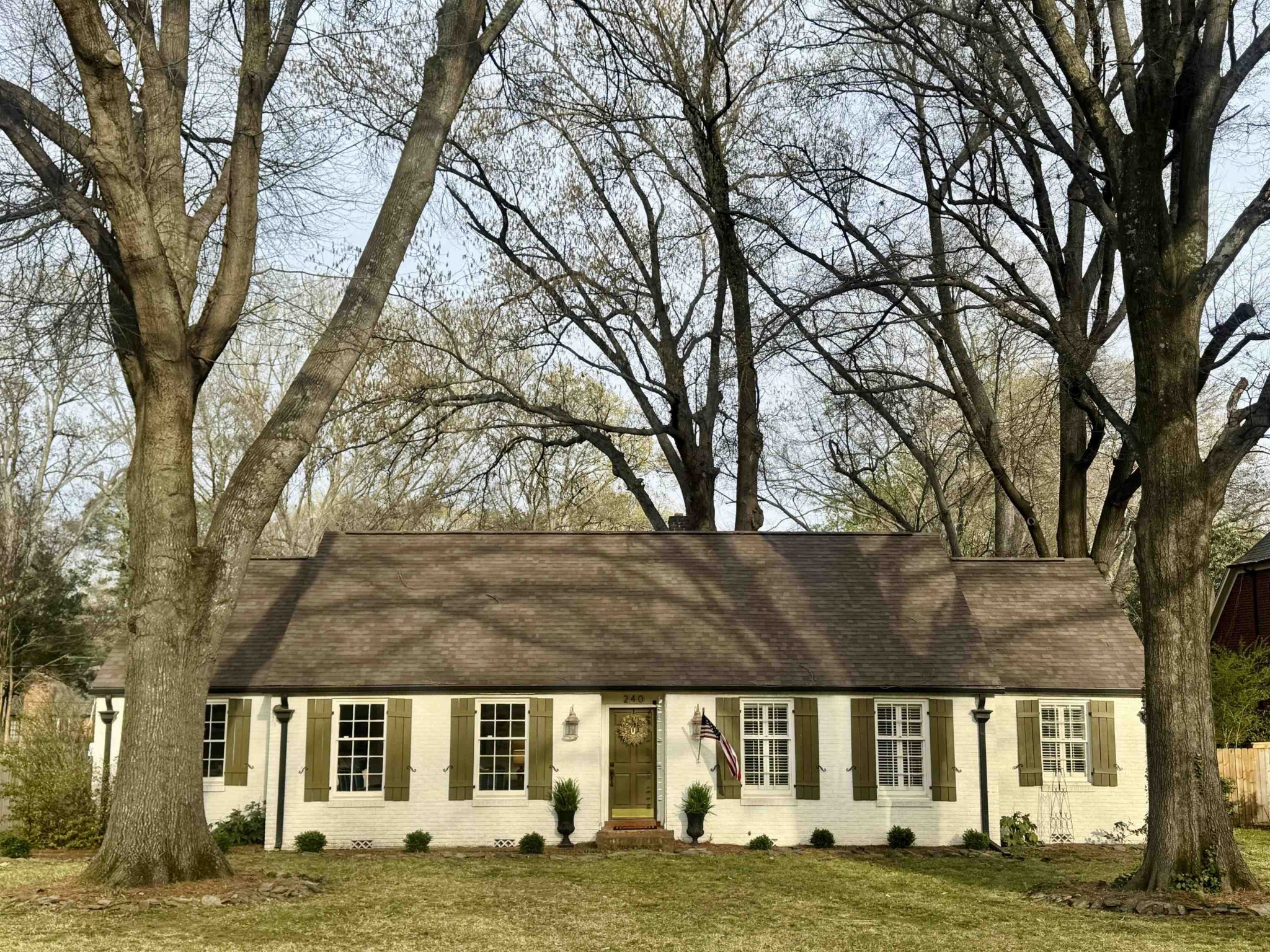 a view of building with yard and trees in the background