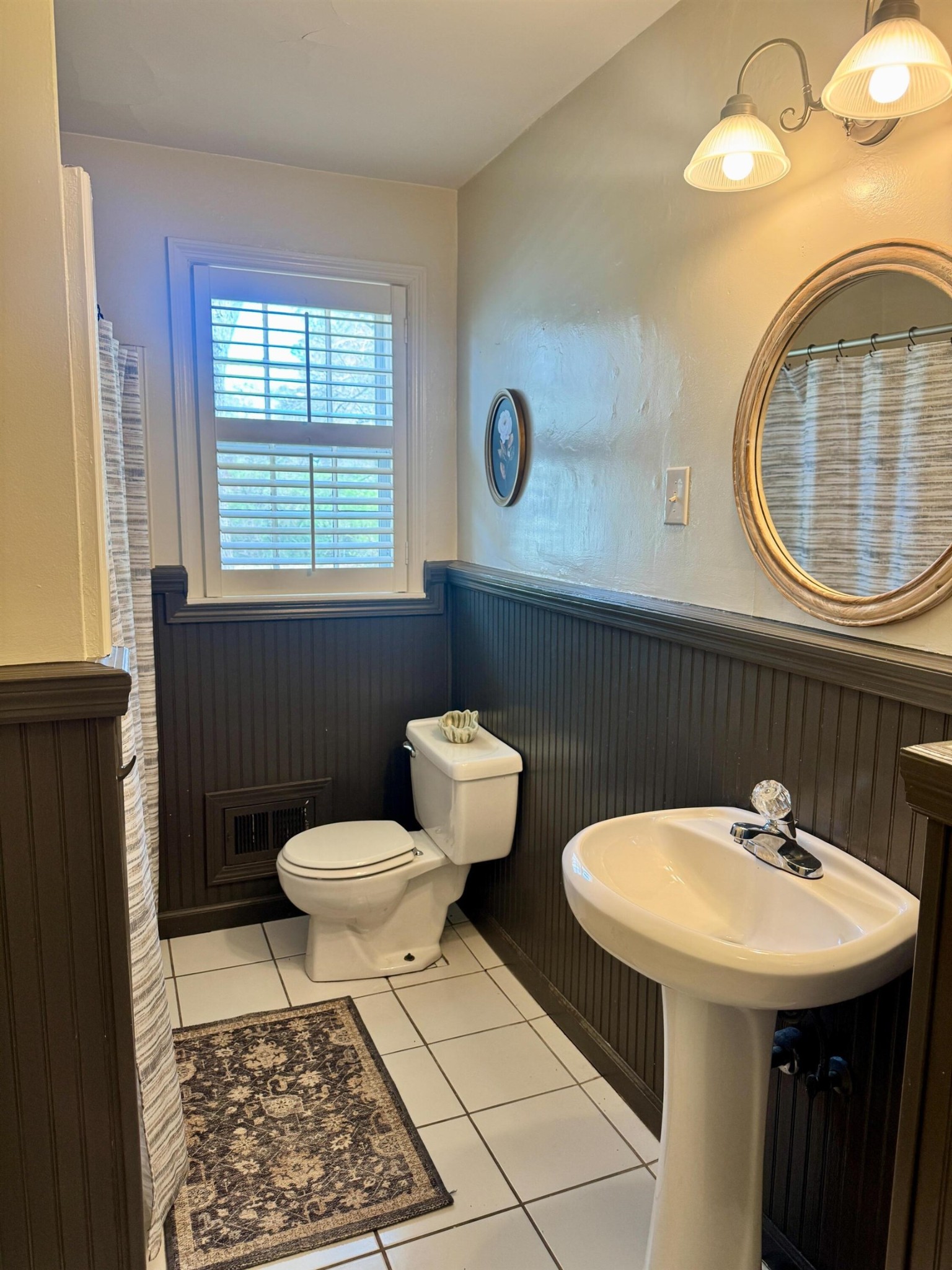 240 Avon Road Memphis, TN 38117 - Photo 11 of 27 a bathroom with a sink a toilet and a mirror