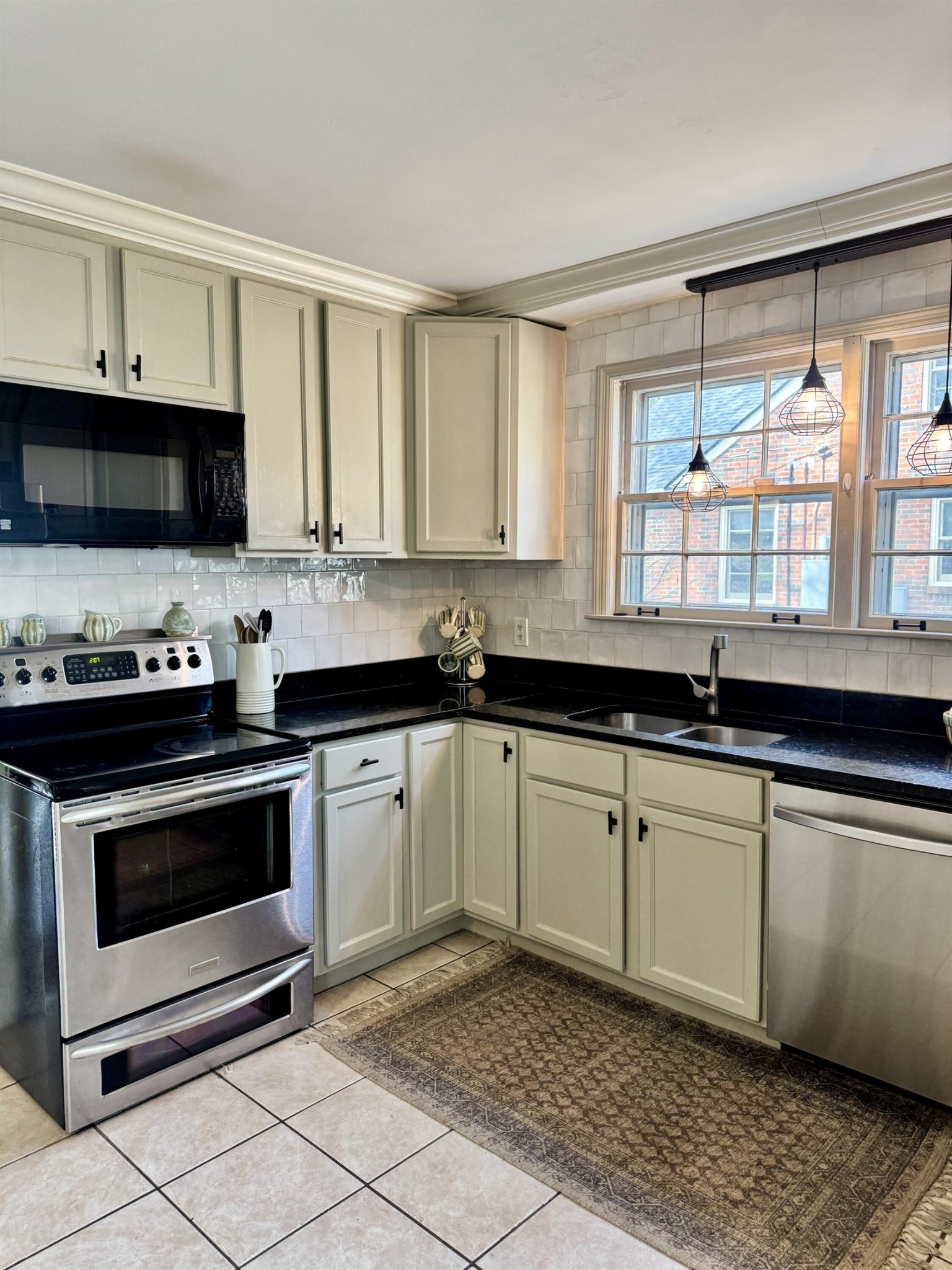 240 Avon Road Memphis, TN 38117 - Photo 17 of 27 a kitchen with granite countertop a sink a stove and microwave