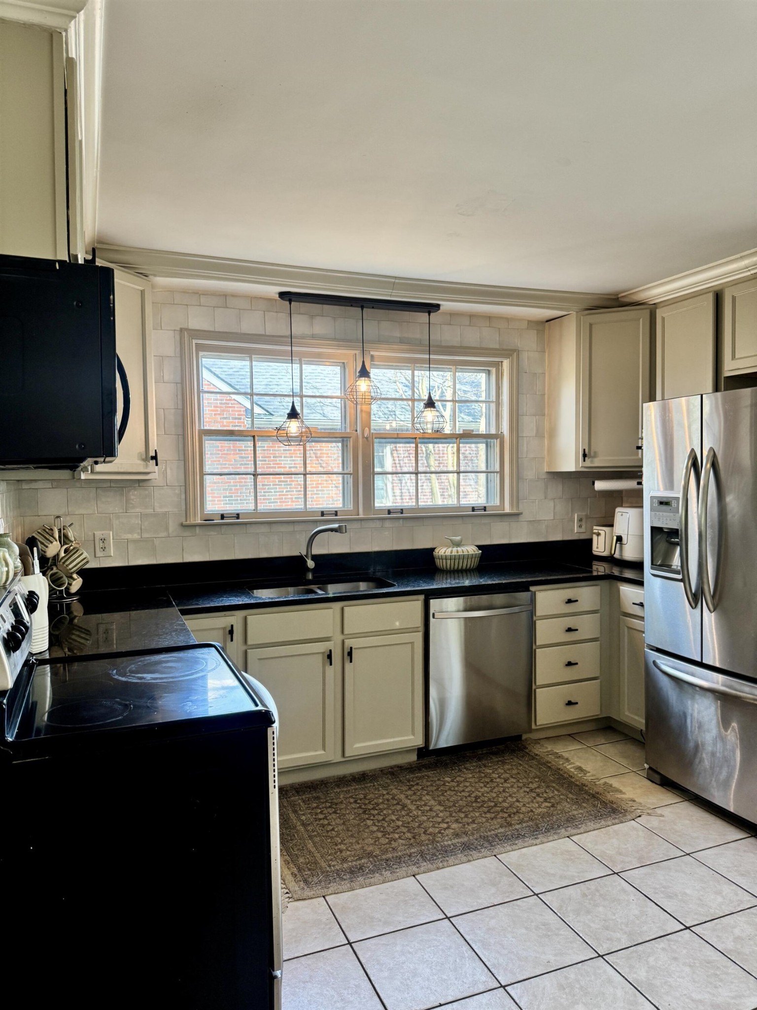 240 Avon Road Memphis, TN 38117 - Photo 18 of 27 a kitchen with granite countertop a sink stainless steel appliances and cabinets