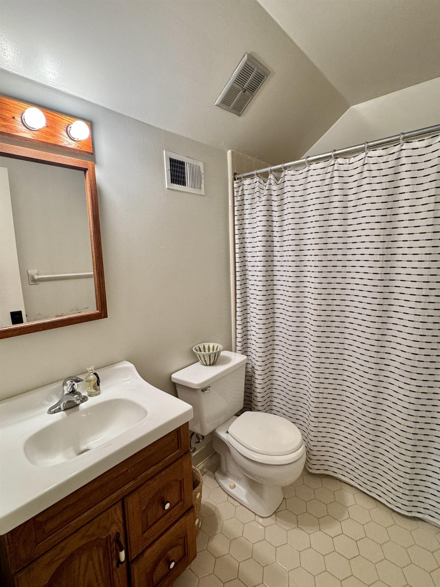 240 Avon Road Memphis, TN 38117 - Photo 20 of 27 a bathroom with a sink a toilet and mirror