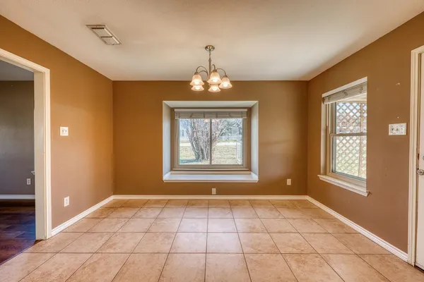a kitchen with granite countertop white cabinets stainless steel appliances and a window