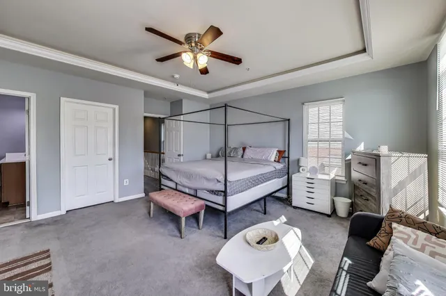 a bedroom with furniture and a chandelier