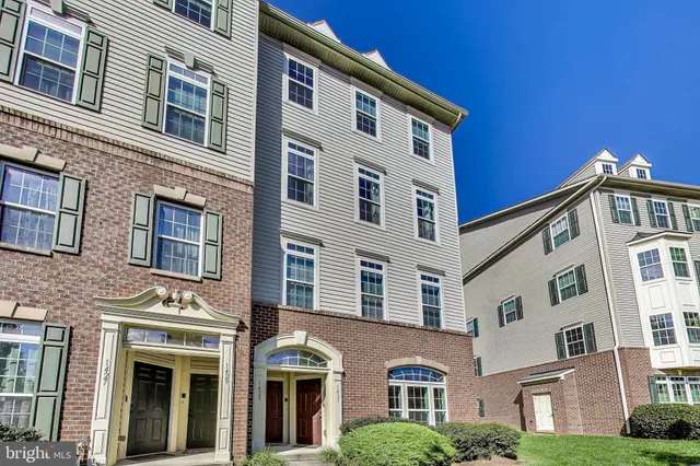 a front view of a building with a yard
