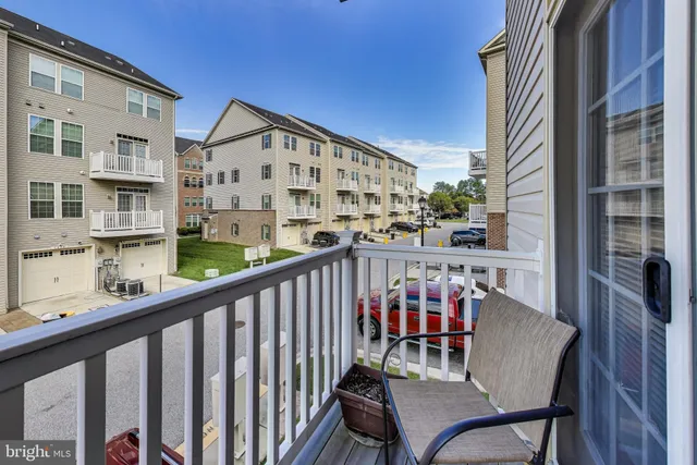 a view of a chairs and table in the balcony