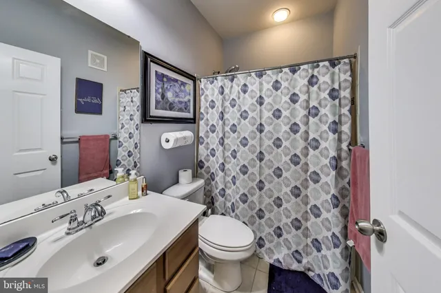 a bathroom with a sink toilet and mirror