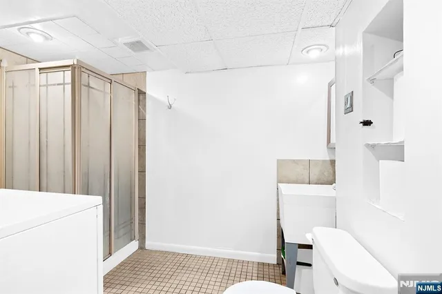 a bathroom with a shower and a toilet
