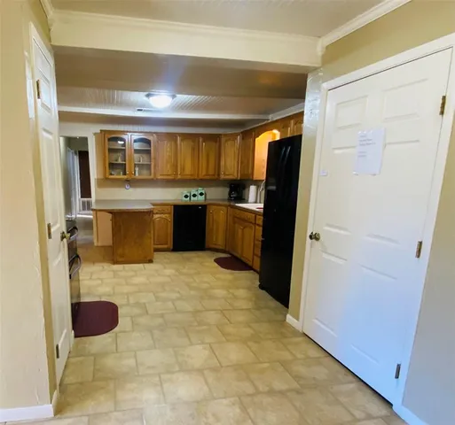 a kitchen with a refrigerator and a sink