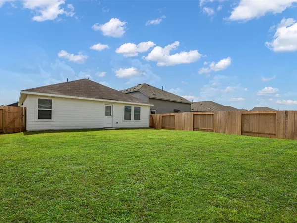 a view of a yard in front of a house with a yard
