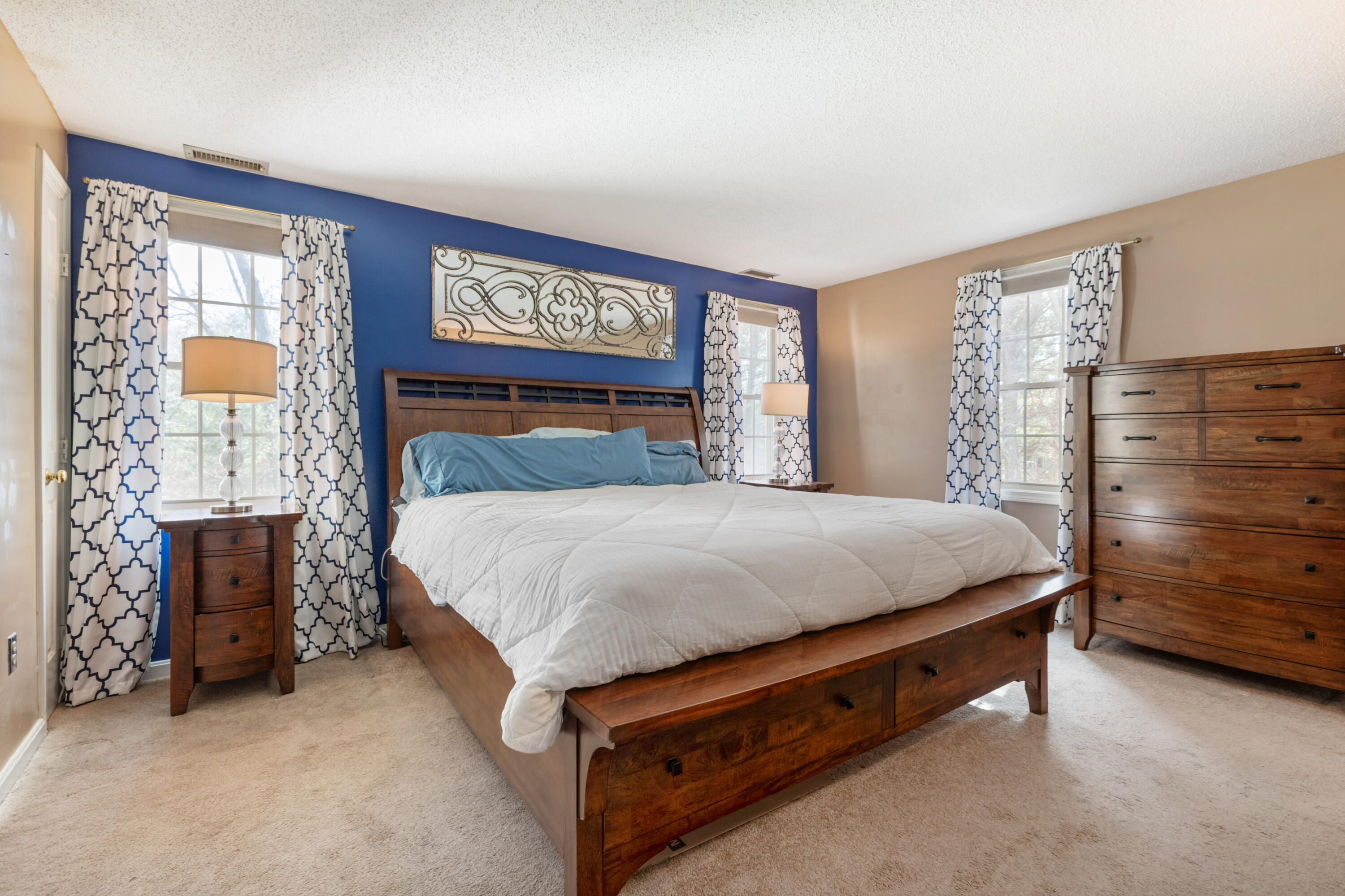 2806 Maple Brook Road Bellingham, MA 02019 - Photo 18 of 38 a bed sitting in a bedroom next to a window with a dresser
