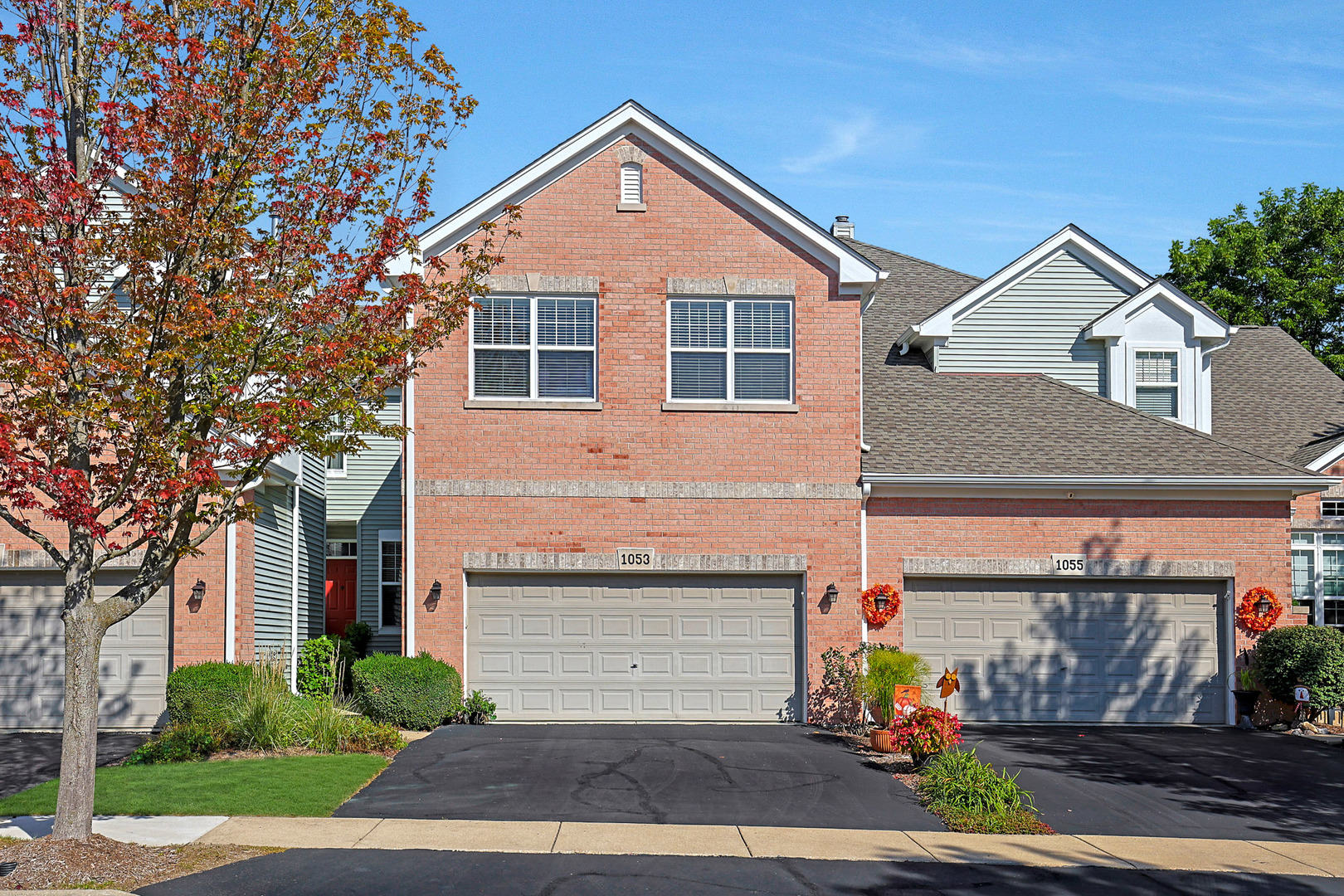 1053 Hummingbird Way Bartlett, IL 60103 - Photo 1 of 6 a front view of a house with a yard and garage