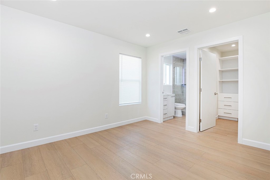 7103 Greeley Street Tujunga, CA 91042 - Photo 14 of 33 wooden floor in an empty room with a window