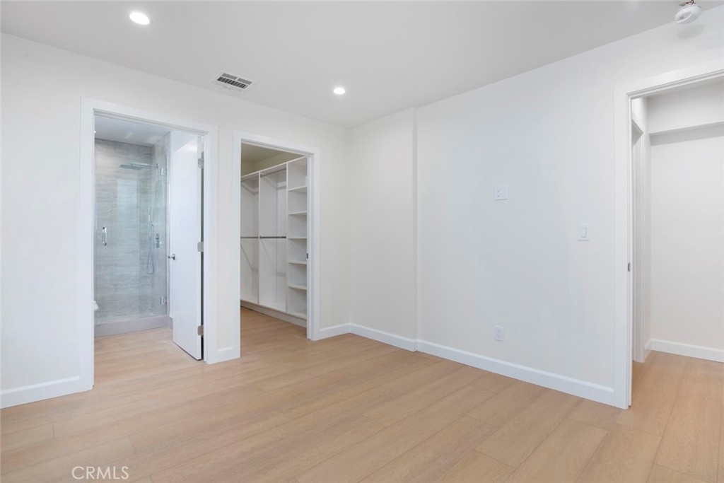 7103 Greeley Street Tujunga, CA 91042 - Photo 15 of 33 an empty room with closet and wooden floor