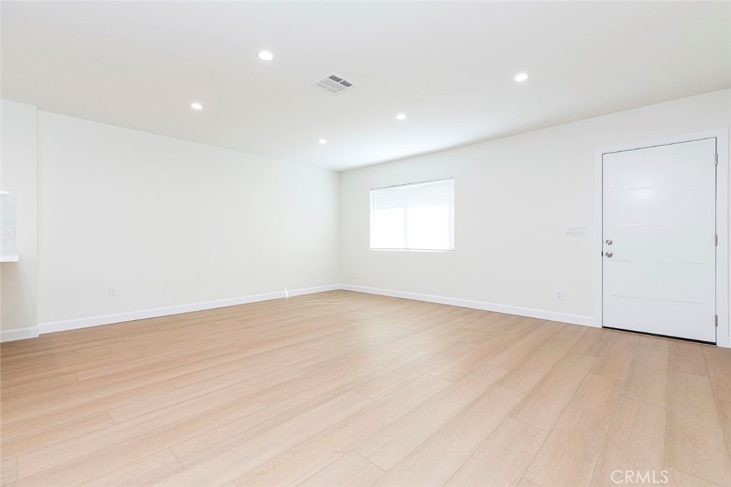 7103 Greeley Street Tujunga, CA 91042 - Photo 3 of 33 an empty room with wooden floor and windows
