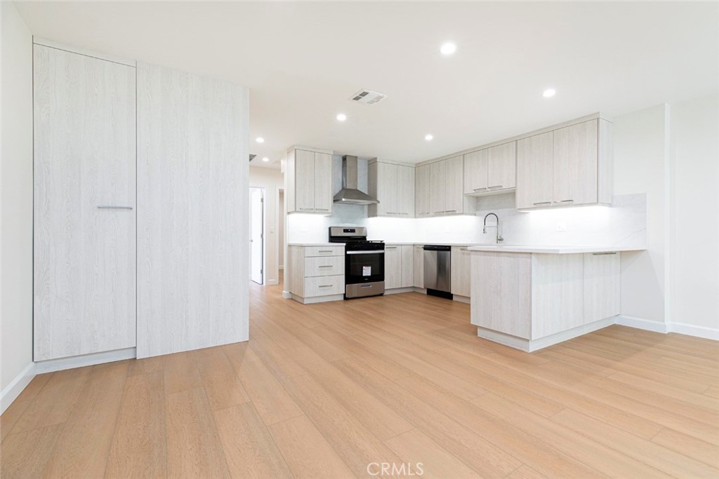 7103 Greeley Street Tujunga, CA 91042 - Photo 6 of 33 a view of kitchen with kitchen island a sink wooden floor and a refrigerator