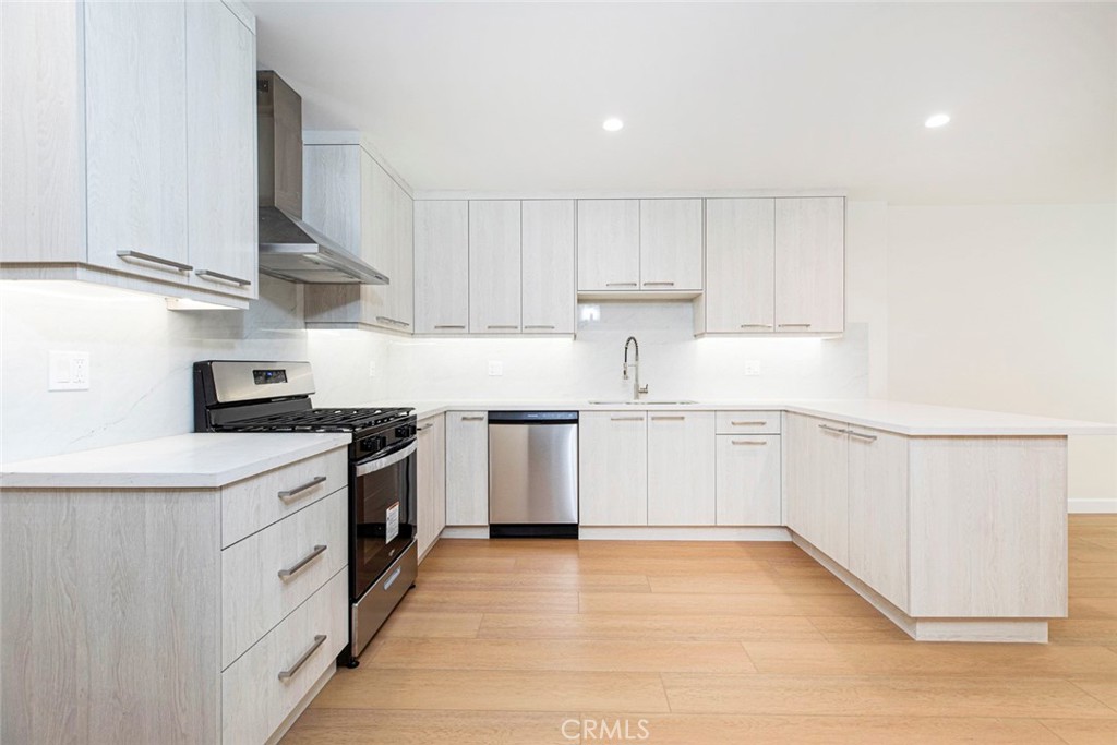 7103 Greeley Street Tujunga, CA 91042 - Photo 7 of 33 a kitchen with a sink a stove and cabinets
