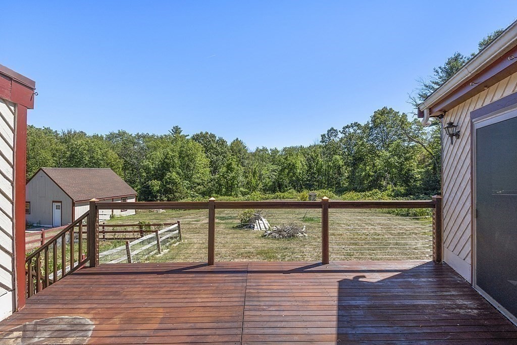 153 Middle Road Boxborough, MA 01719 - Photo 16 of 36 a view of a terrace with wooden floor and fence