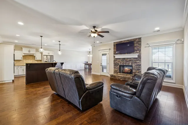 a living room with furniture a fireplace and a flat screen tv