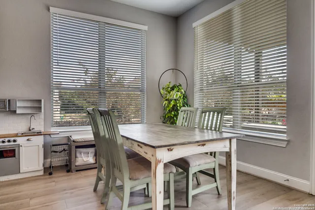 a view of a dining room with furniture and window
