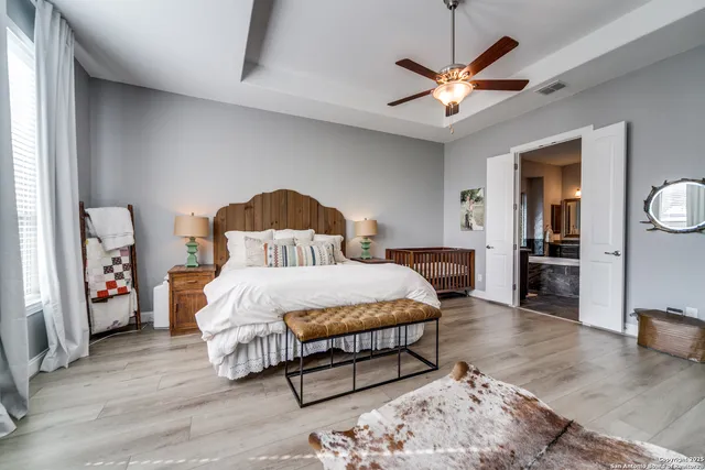 a bedroom with a bed and a ceiling fan