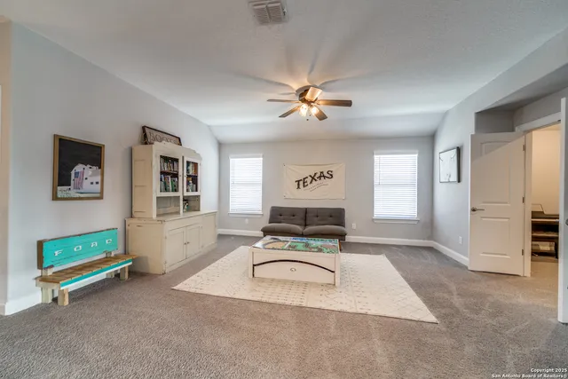 a living room with furniture gym equipment and a window