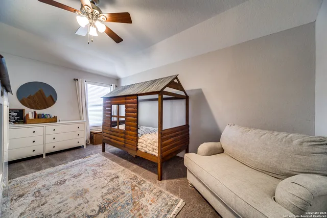 a bedroom with furniture and a window