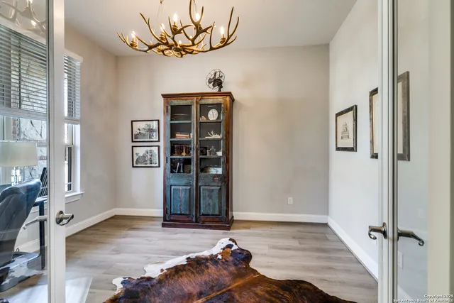 a view of a room with wooden floor and windows